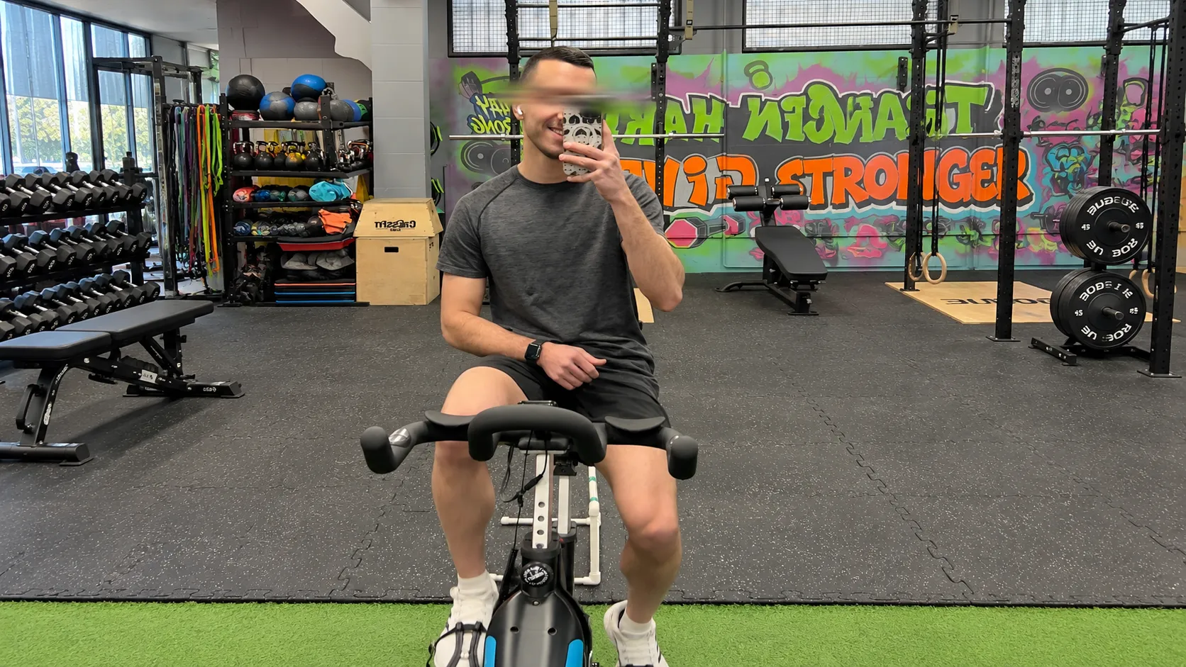 Me on a stationary bicycle, in a gym mirror selfie
