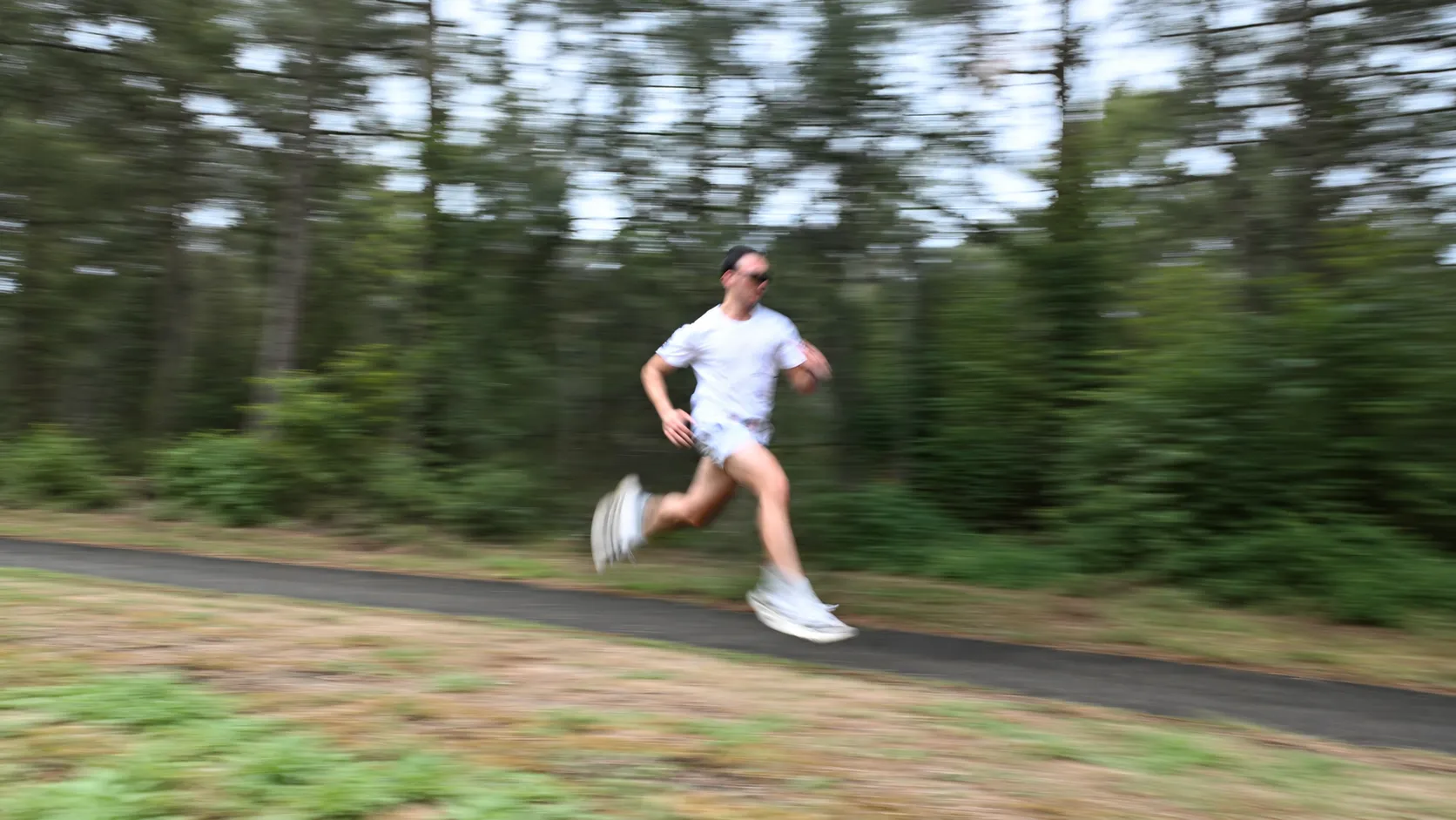 Me running on a tree-lined path, the background blurred by motion